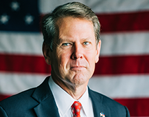 Gov Kemp with Flag 217x170